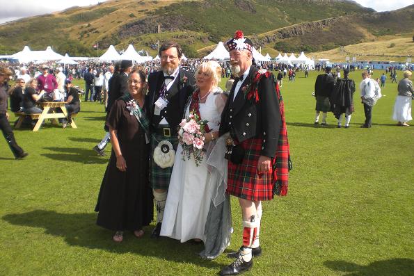 happy couple with preacher and his wife